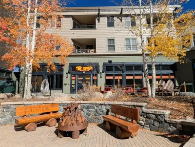 a park with benches in front of a building at Red Hawk Lodge 2242 by SummitCove Lodging in Keystone