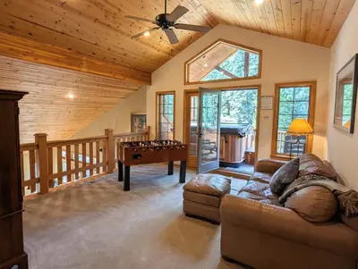 a living room with a pool table and a wooden ceiling at Goldenrod Home 88 by SummitCove Lodging in Keystone