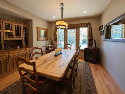 a dining room with a wooden table and chairs at Goldenrod Home 88 by SummitCove Lodging in Keystone