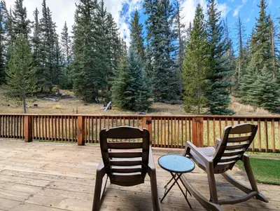 two chairs and a table on a deck at Goldenrod Home 88 by SummitCove Lodging in Keystone