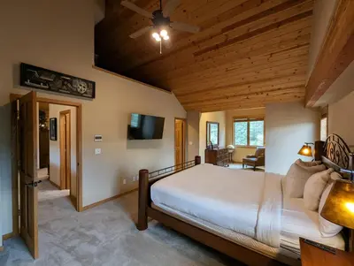 a bedroom with a large bed and a ceiling fan at Goldenrod Home 88 by SummitCove Lodging in Keystone