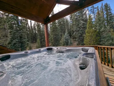 a hot tub on the deck of a cabin at Goldenrod Home 88 by SummitCove Lodging in Keystone