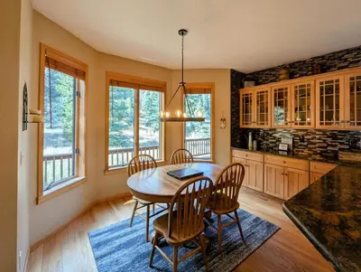 a kitchen with a dining room table and chairs at Goldenrod Home 88 by SummitCove Lodging in Keystone