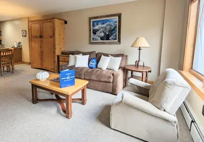 a living room with a couch and a table at Springs 8886 by SummitCove Lodging in Keystone