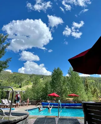 a pool at a resort with people swimming at Dakota Lodge 8499 by SummitCove Lodging in Keystone
