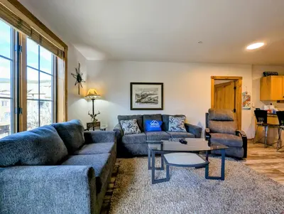 a living room with a couch and a table at Dakota Lodge 8499 by SummitCove Lodging in Keystone