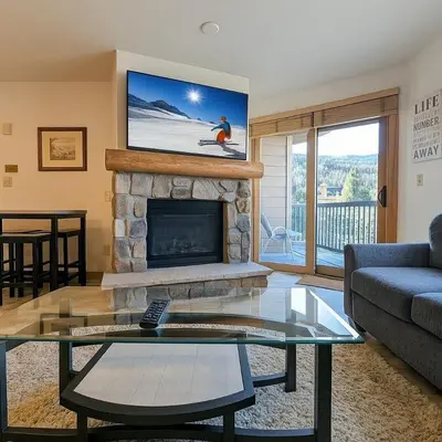 a living room with a couch and a fireplace at Dakota Lodge 8499 by SummitCove Lodging in Keystone