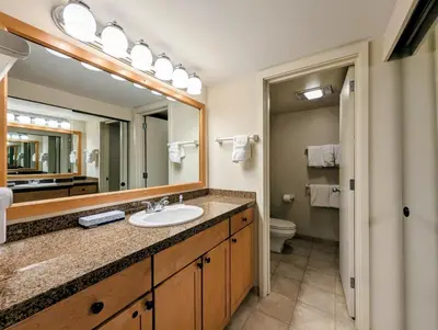 a bathroom with a sink and a mirror at Saints John 2525 by SummitCove Lodging in Keystone
