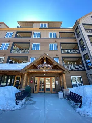 a large building with snow in front of it at Dakota Lodge 8451 by SummitCove Lodging in Keystone