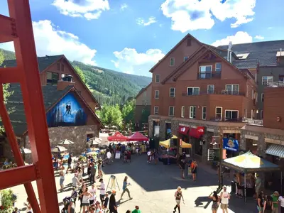 a group of people walking around a market in a town at Dakota Lodge 8451 by SummitCove Lodging in Keystone