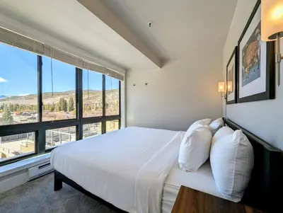 a bedroom with a large bed and a large window at Slopeside 2793B by SummitCove Lodging in Keystone