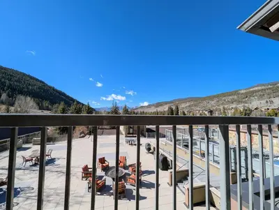 a view from a balcony with tables and chairs at Slopeside 2793B by SummitCove Lodging in Keystone