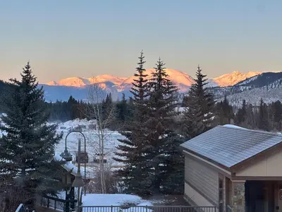 a house with a view of a snow covered mountain at Slopeside 2793B by SummitCove Lodging in Keystone