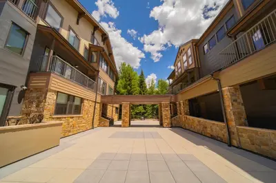 an empty alley between two buildings with trees in the background at Slopeside 2793B by SummitCove Lodging in Keystone