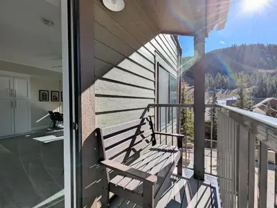 a balcony with a bench on a house at Slopeside 2793B by SummitCove Lodging in Keystone