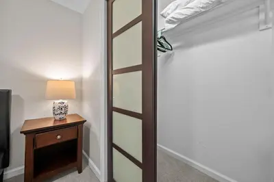 a closet with a glass door next to a table with a lamp at 1815 Bluebell New in Boulder