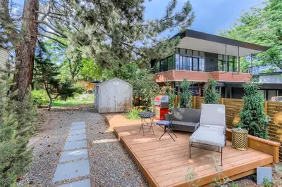 a backyard with a wooden deck and a house at 1815 Bluebell New in Boulder