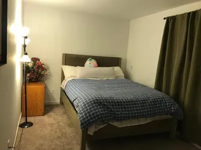 a bedroom with a bed with a pillow on it at 4 Bedroom Vacation House With Pikes Peak view Pet-friendly in Aurora