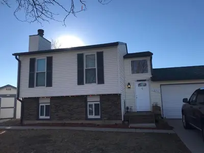 a house with a car parked in front of it at 4 Bedroom Vacation House With Pikes Peak view Pet-friendly in Aurora