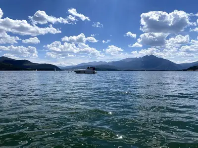 a boat on a large body of water at Lake & Mountain Views, 2BR, 2 BA in Dillon
