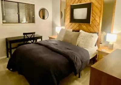 a bedroom with a bed and a table and two lamps at Lake & Mountain Views, 2BR, 2 BA in Dillon