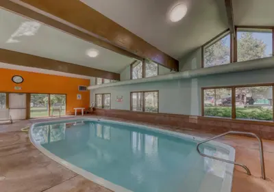 a large swimming pool in a building with windows at Lake & Mountain Views, 2BR, 2 BA in Dillon