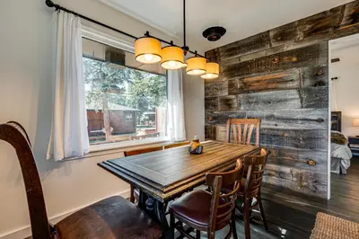 a dining room with a wooden table and chairs at Mtn-View Retreat with Deck and Hot Tub in Estes Park! in Estes Park