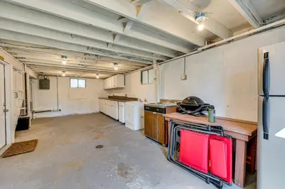 an empty kitchen with a refrigerator and appliances at Mtn-View Retreat with Deck and Hot Tub in Estes Park! in Estes Park