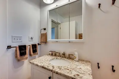 a bathroom with a sink and a mirror at Mtn-View Retreat with Deck and Hot Tub in Estes Park! in Estes Park