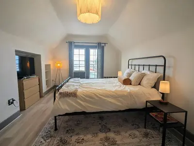 a bedroom with a large bed and a television at The Green House, RiNo in Denver