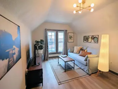 a living room with a couch and a table at The Green House, RiNo in Denver