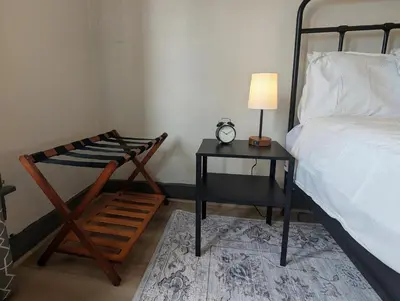a bedroom with a bed and a table with a lamp at The Green House, RiNo in Denver