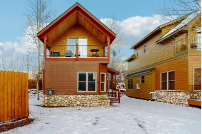 a house with a balcony on top of it at Grizzly Peak Lodge in Granby