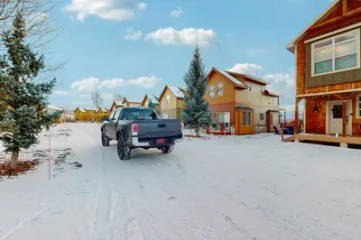 a truck parked on a snow covered street at Grizzly Peak Lodge in Granby