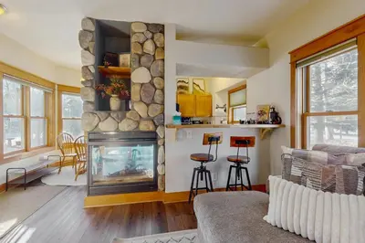 a living room with a fireplace and a couch at Grizzly Peak Lodge in Granby