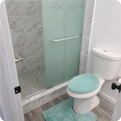 a bathroom with a toilet and a glass shower at Sweet stay near Denver airport in DEN