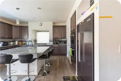 a kitchen with a large island with bar stools at Sweet stay near Denver airport in DEN