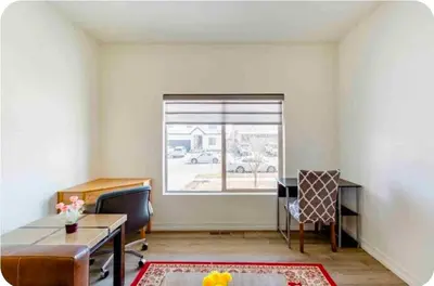 an office with a desk and chairs and a window at Sweet stay near Denver airport in DEN