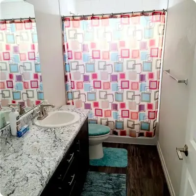 a bathroom with a toilet and a shower curtain at Sweet stay near Denver airport in DEN