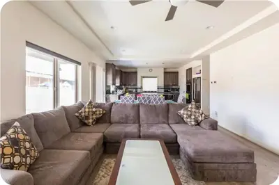 a living room with a brown couch and a table at Sweet stay near Denver airport in DEN