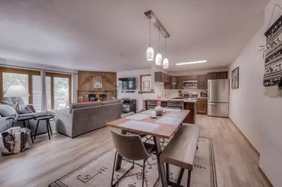 a kitchen and living room with a table and chairs at Keystone Condo, Walking Distance to Ski Lift in Keystone