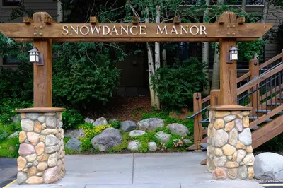 a sign for a snow dance manor in a garden at Keystone Condo, Walking Distance to Ski Lift in Keystone