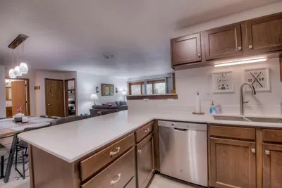 a kitchen with a counter top and a living room at Keystone Condo, Walking Distance to Ski Lift in Keystone