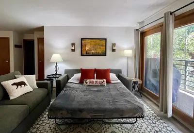a living room with a bed and a couch at Keystone Condo, Walking Distance to Ski Lift in Keystone