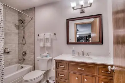 a bathroom with a toilet and a sink and a mirror at Keystone Condo, Walking Distance to Ski Lift in Keystone