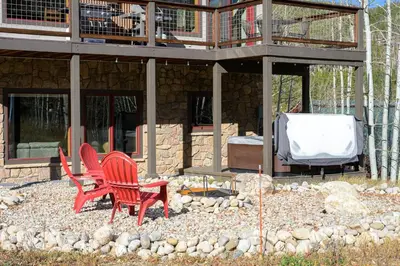 two red chairs sitting in front of a house at Ski Inn Condo condo in Winter Park