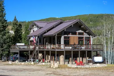 a large house with a gambrel roof at Ski Inn Condo condo in Winter Park