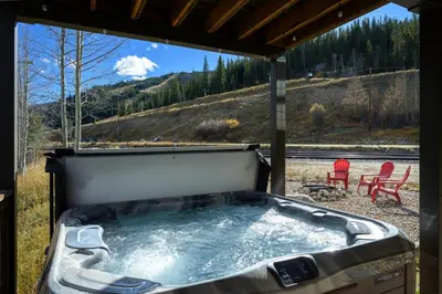 a jacuzzi tub with a view of a mountain at Ski Inn Condo condo in Winter Park