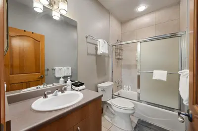 a bathroom with a sink and a toilet and a shower at Ski Inn Condo condo in Winter Park