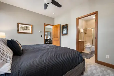 a bedroom with a bed and a bathroom at Ski Inn Condo condo in Winter Park